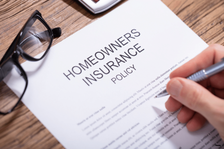 Someone filling homeowners insurance form