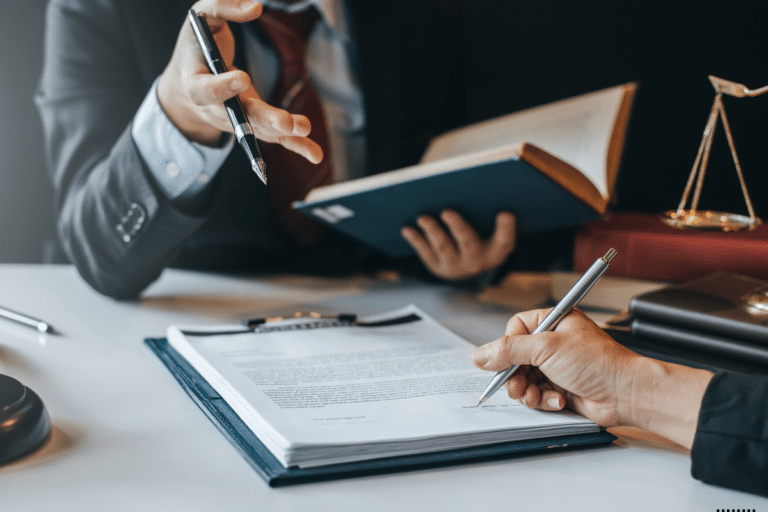 A lawyer holding a law book explaining something to a client