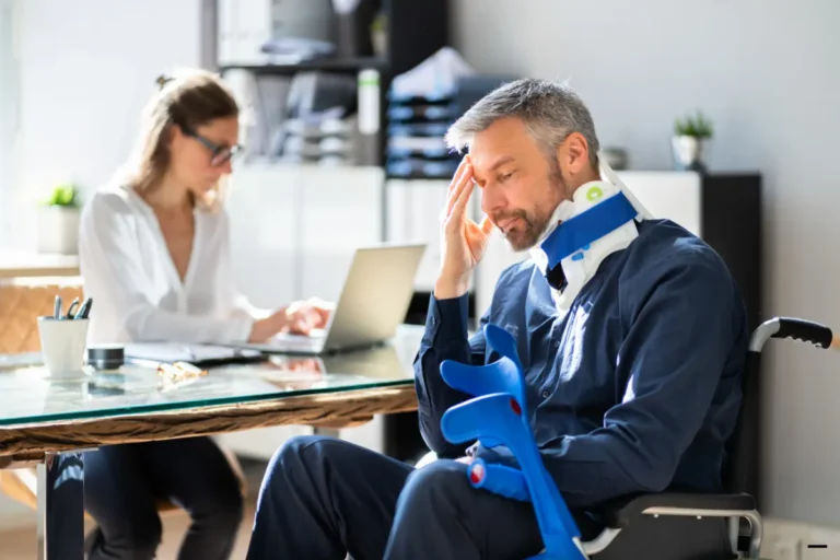 A lady talking to an injured man on a wheel chair