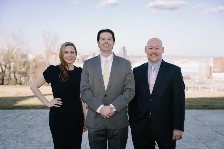 Attorneys for Lawrence & Associates posting for a photo in front of a skyline