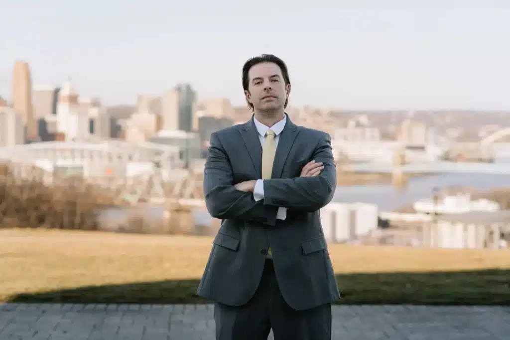Attorney Justin Lee Lawrence posting for a photo in front of a skyline