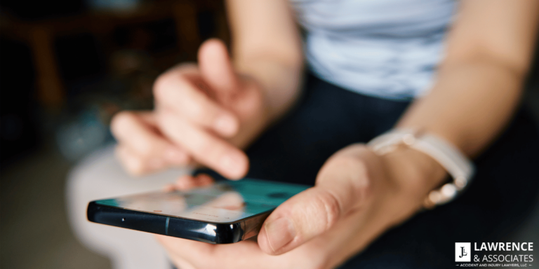 Close up of a persons hands using their cellphone